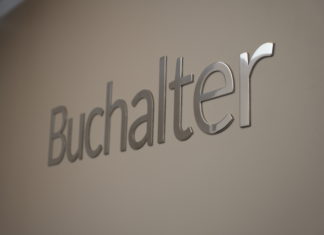 Buchalter Expands Business Law Footprint with New Denver Office Silver chrome letters on a white wall spell out Buchalter.