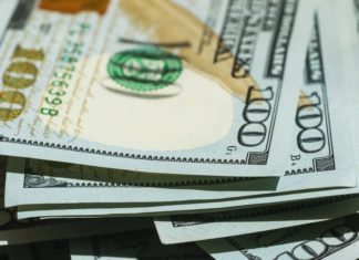 Confidence Index: Colorado Business Leaders Pessimistic for Start of 2023 Stacks of $100 bills are strewn about.