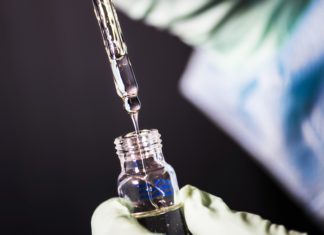 Dottie Wham, a Brief History of Public Health Reporting a laboratory technician is in the process of pipetting a sample of vitamin E acetate.