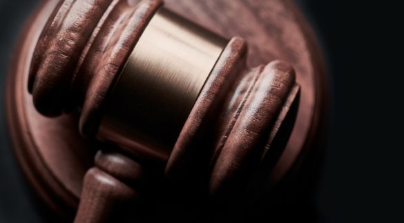 a gavel sits on a desk in low light