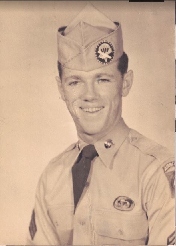 Gardner Paul Smith is sitting for a portrait in what looks like an airforce military uniform. The uniform and the photo look old.