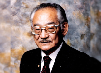 Minoru Yasui’s Legacy Lives on in Colorado and Beyond A man with graying hair wears glasses poses for a picture wearing a suit.