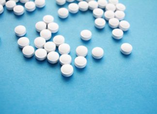 What Mifepristone Rulings Mean for Colorado and Beyond A group of small white pills on a blue background.