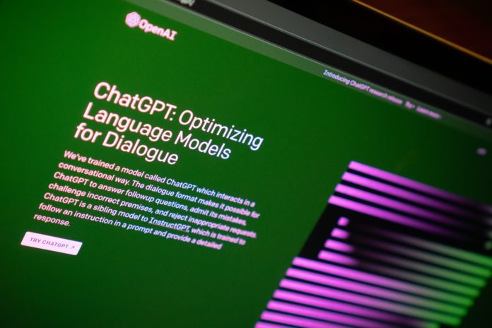An image of a computer screen showing a website for OpenAI with a green background and what appears to be a digital box of purple and black stripes on the right hand side. Part of the text reads “ChatGPT: Optimizing Language Models for Dialogue.”