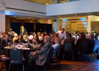 CTLA Names ‘Case of the Year,’ Honors Members at 2023 Banquet A wide shot of a formal banquet in a large atrium. People in formal clothes sit around round tables, some speaking to each other and others looking toward the left.