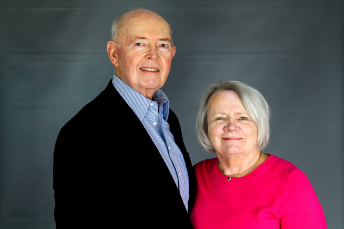 Photo for Law Week Colo 5.2.23 A man wearing a suit coat and a woman wearing a pink top pose for a picture with a gray background.