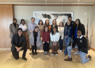 Colorado’s Law School… Yes We Can! Continues Work Helping Underrepresented Students A group of people from many different backgrounds pose for a picture with a unique image or painting behind them.