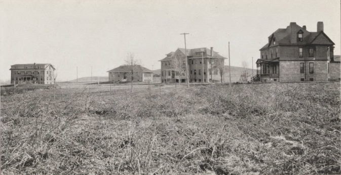 Four historical buildings are scattered across an open-looking plain.