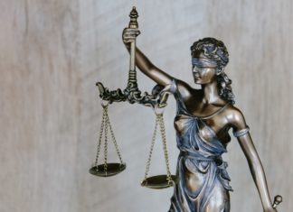 A Brief History of Colorado’s No-Fault Divorce A bronzed statue of lady justice holds her scales aloft while a sword dangles loosely from her other hand.