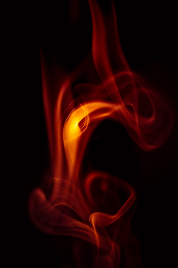 An orange flame with a black background.