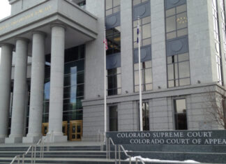 Colorado Supreme Court Grants Petition in Masterpiece Cakeshop Case A large building made of concrete has multiple windows and has large columns at the front. Near the front entrance a sign reads “Colorado Supreme Court” and “Colorado Court of Appeals.”