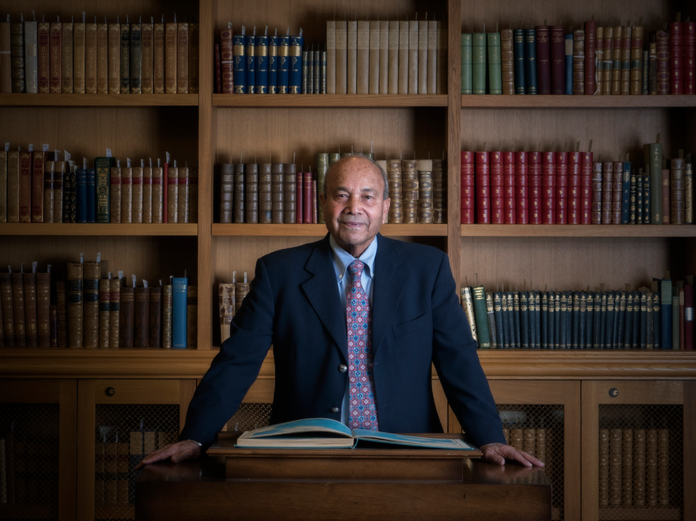 Professor Ved Nanda standing in a suit and tie.