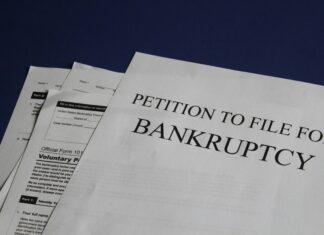 US Bankruptcy Filings Rose in 2023 papers on a desk say “petition to file for bankruptcy”