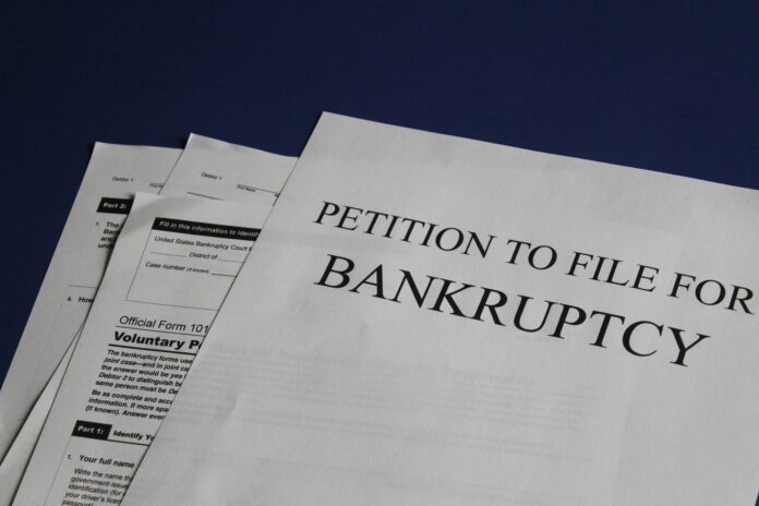 papers on a desk say “petition to file for bankruptcy”