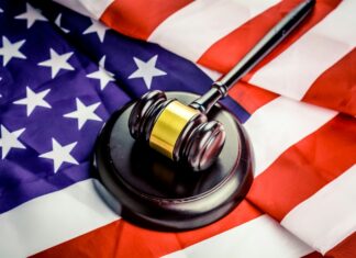 ABA Releases Guidance on Misuse of ‘Confidential Government Information’ A gavel rests on top of an American flag
