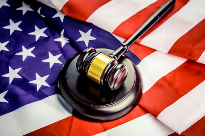 A gavel rests on top of an American flag