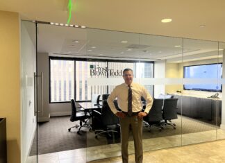 Frost Brown Todd Opens in Denver with Ambitious Plans Managing Partner of Frost Brown Todd's Denver office stands in front of the new office's conference room.