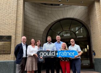 Gould & Ratner LLP Opens Denver Office A group from the law firm Gould & Ratner stand with the firm’s black and blue sign in front of the firm’s new office in Denver.