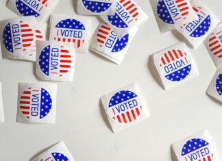Court Orders: Supreme Court Allows Arizona Proof-of-Citizenship Law to Rule for 2024 Presidential Election stickers say “I voted” against a white background