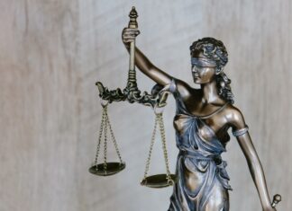 ABA Releases Opinion About Rule to Reduce Risk of Assisting in Crime or Fraud Through Representation lady justice holds her scales aloft while her sword dangles loosely at her side.