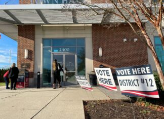 Judicial Discipline, Changes to Parole, Police Funding on Ballot for the 2024 Election A polling center, with signs saying vote here and a woman at the front door.
