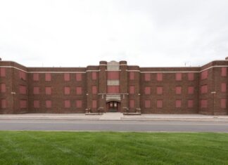 Colorado’s Long Path Toward Mental Health Reform A long red brick building with grass in the foreground