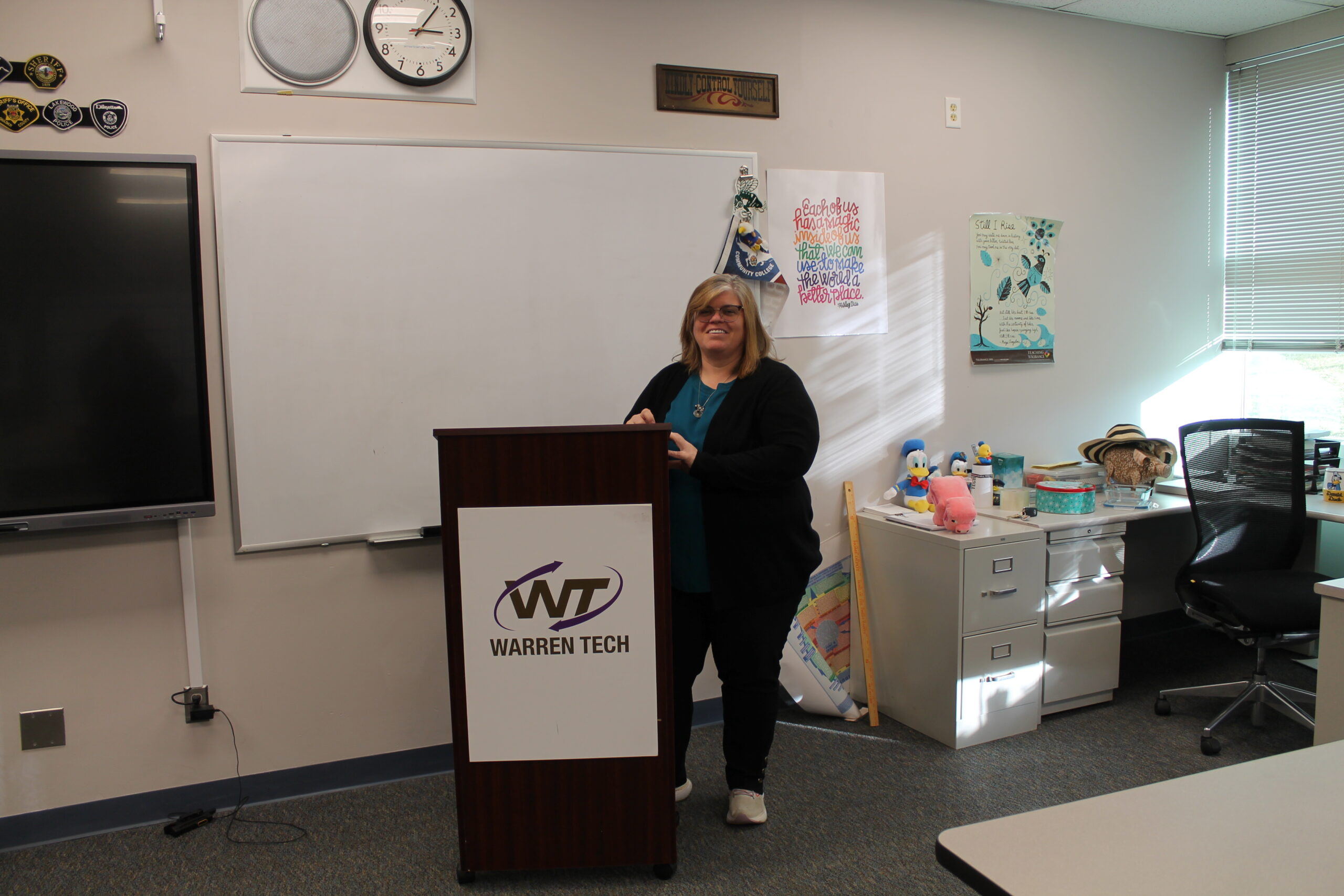Valarie Purl stands behind a podium at the front of her classroom at Warren Tech North.
