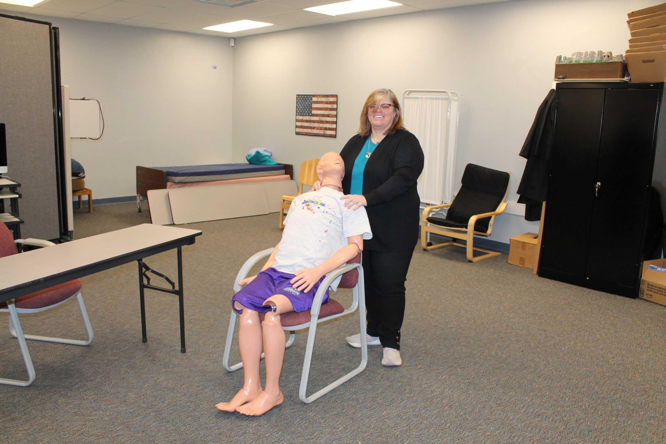 Valarie Purl stands behind a lightly bloodied lab dummy named Bruce in the program’s lab room just outside of the classroom at Warren Tech North.