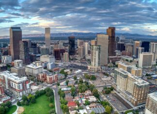General Assembly Passes Measure to Expand Colorado’s Law Prohibiting Local Anti-Growth Ordinances Downtown Denver from above, with several apartment buildings and commercial buildings in the foreground. The foothills of the Rocky Mountains can be seen in the background.