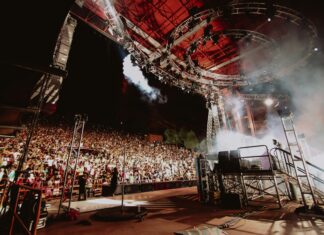 The Lawsuit to End Red Rocks Rock ’n’ Roll Restrictions A view of a Red Rocks amphitheatre from the stage, with a nearly full crowd.
