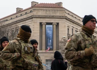 Large banner featuring Trump’s face is displayed on Justice Department